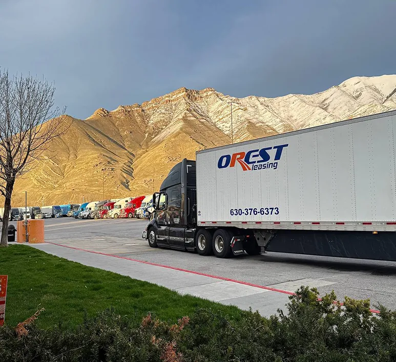 OREST Express tractor-trailer parked in front of mountains