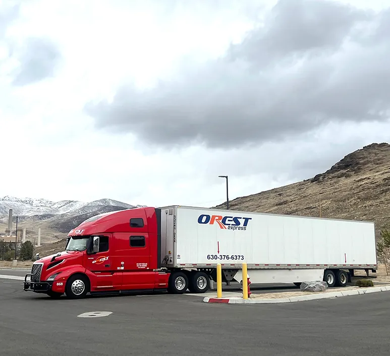 Red OREST Express tractor-trailer at a mountain truck stop